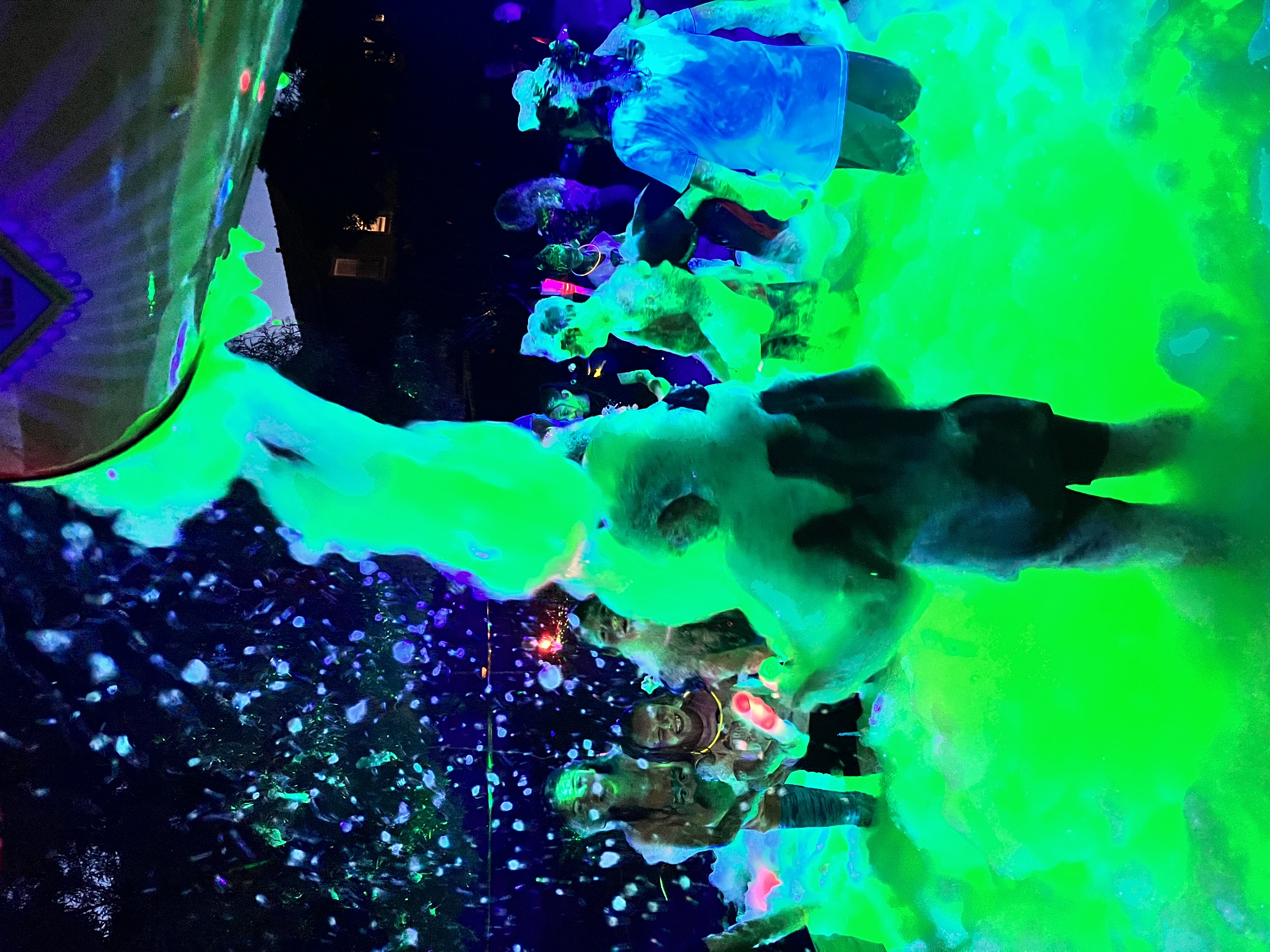 Guests enjoying a glowing nighttime foam party
